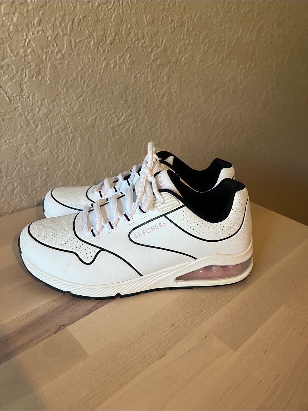 Skechers women’s White Athletic Sneakers with Black Lining